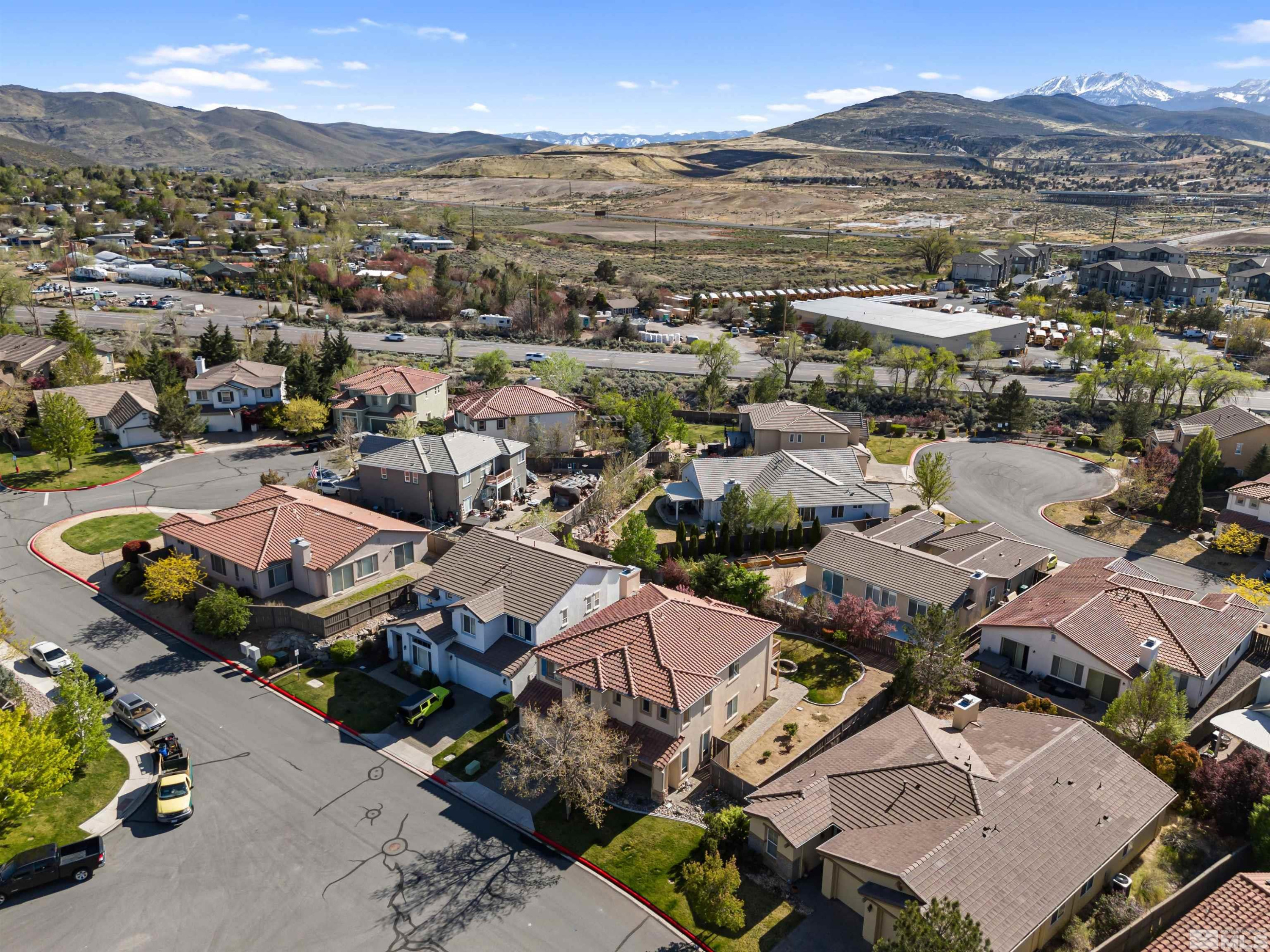 14025 Tagor Road Reno, NV 89521 - Photo 36 of 39 an aerial view of a city with lots of residential buildings and mountain view in back
