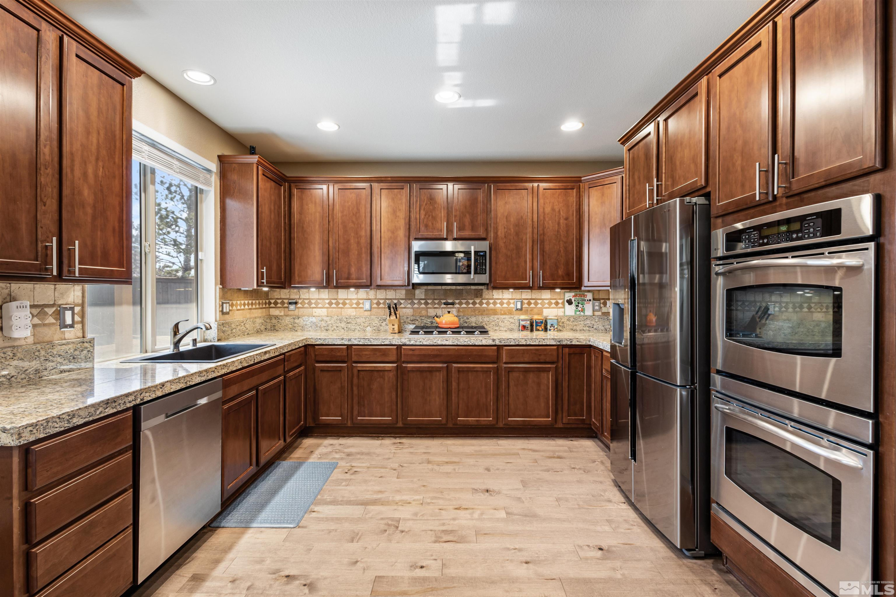 14025 Tagor Road Reno, NV 89521 - Photo 10 of 39 a kitchen with stainless steel appliances granite countertop a refrigerator stove and sink
