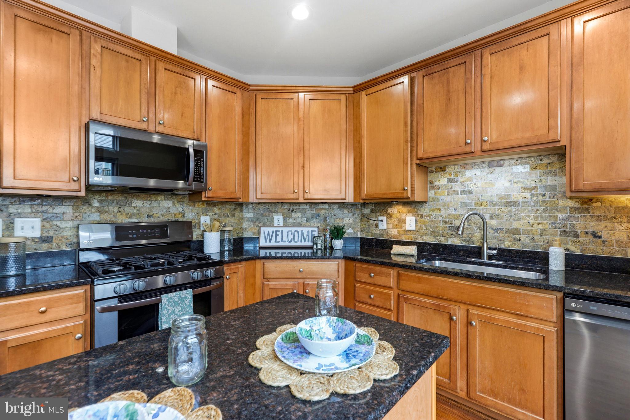 224 North Summit Avenue Gaithersburg, MD 20877 - Photo 14 of 34 a kitchen with stainless steel appliances granite countertop a stove top oven a sink dishwasher and microwave oven
