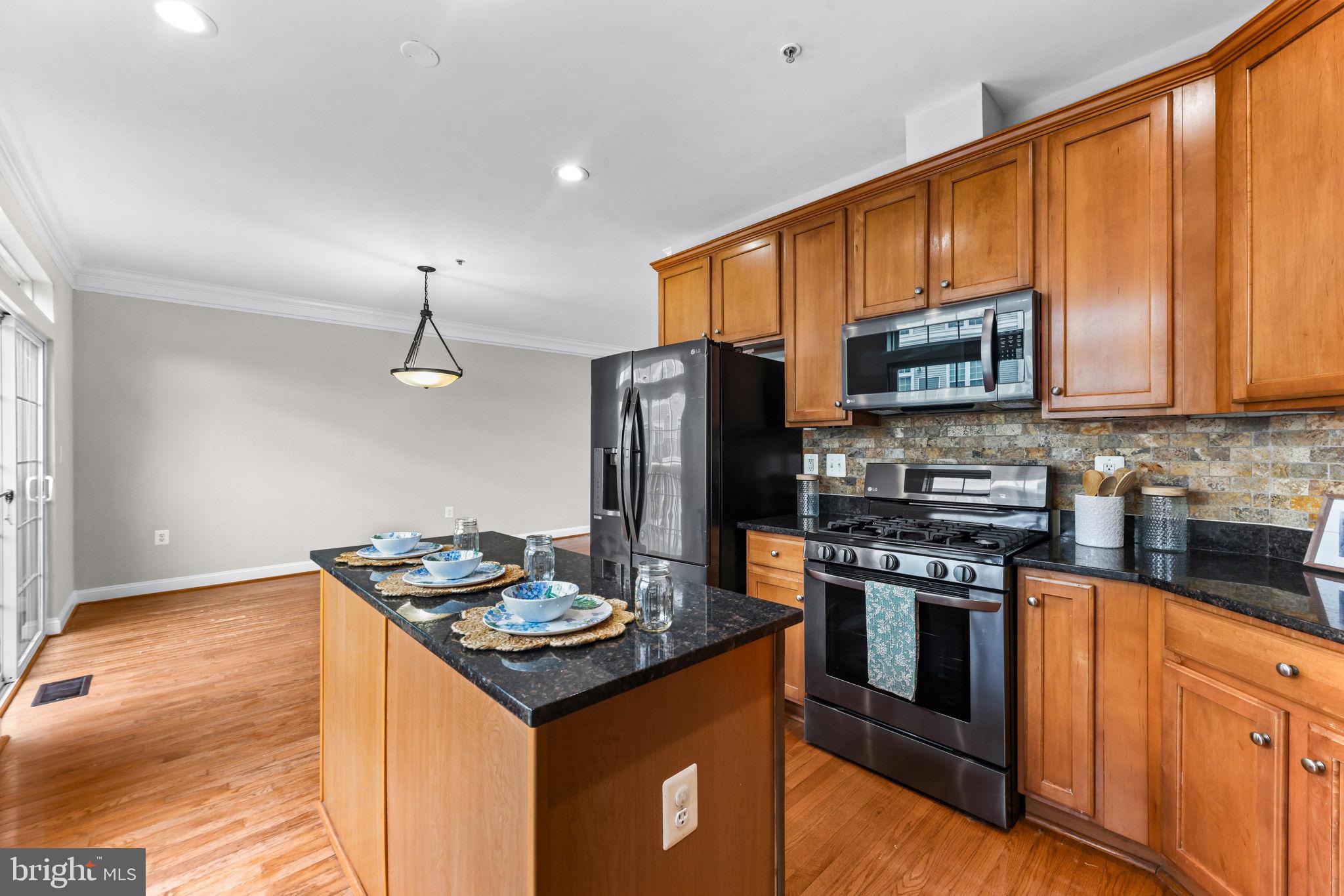 224 North Summit Avenue Gaithersburg, MD 20877 - Photo 15 of 34 a kitchen with stainless steel appliances granite countertop a stove refrigerator sink and microwave