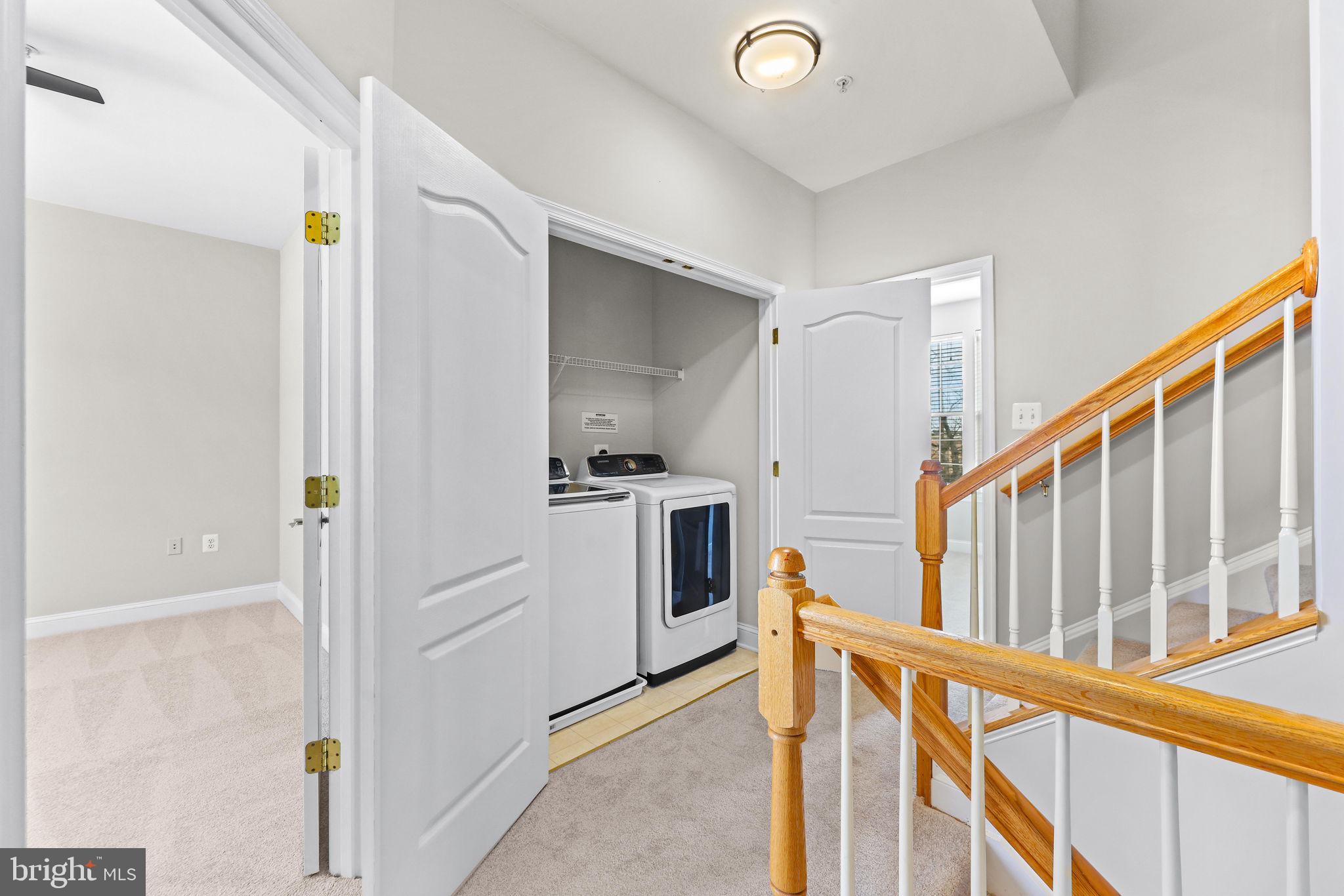 224 North Summit Avenue Gaithersburg, MD 20877 - Photo 20 of 34 a view of a kitchen with white cabinets and stainless steel appliances