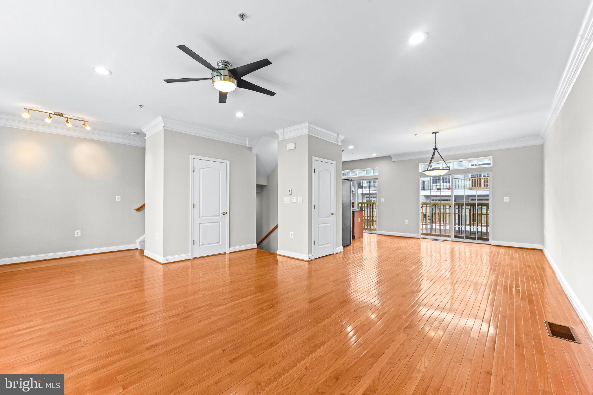 224 North Summit Avenue Gaithersburg, MD 20877 - Photo 8 of 34 a view of an empty room with wooden floor and a ceiling fan