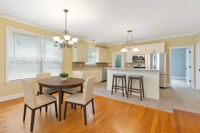 a view of a dining room with furniture and chandelier