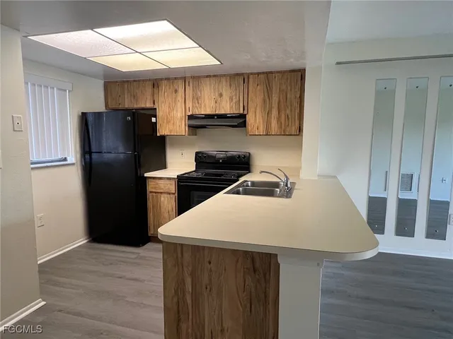 a kitchen with a refrigerator and a sink