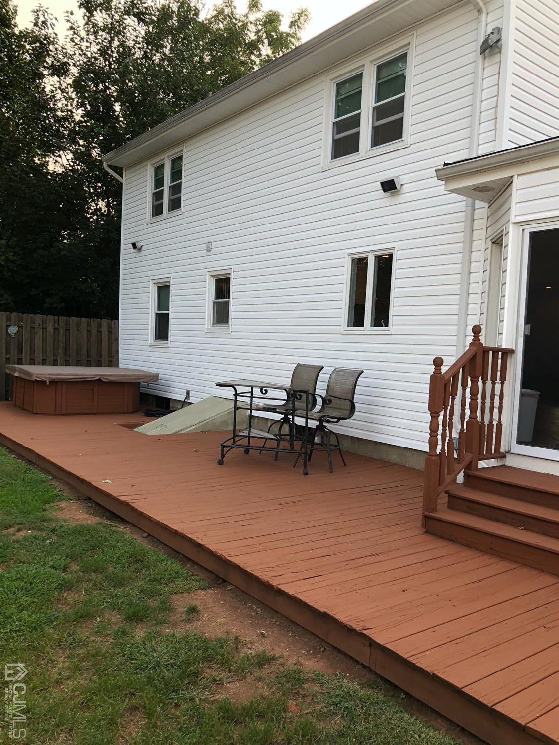 44 Hillcrest Road Colonia, NJ 07067 - Photo 22 of 23 a view of a patio with table and chairs with wooden floor and fence