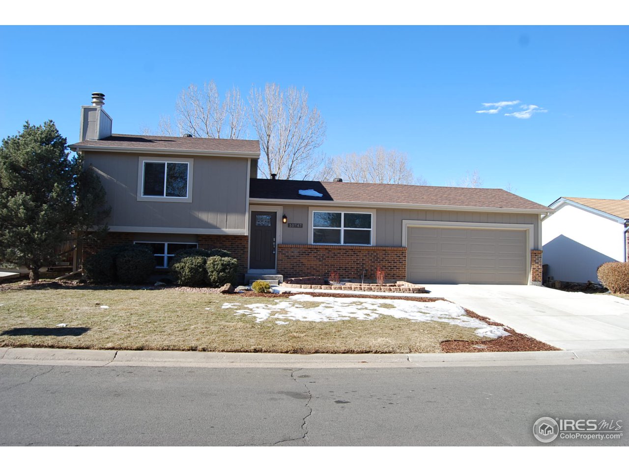 10747 Routt Street Westminster, CO 80021 - Photo 1 of 10 a view of a house with snow on the road