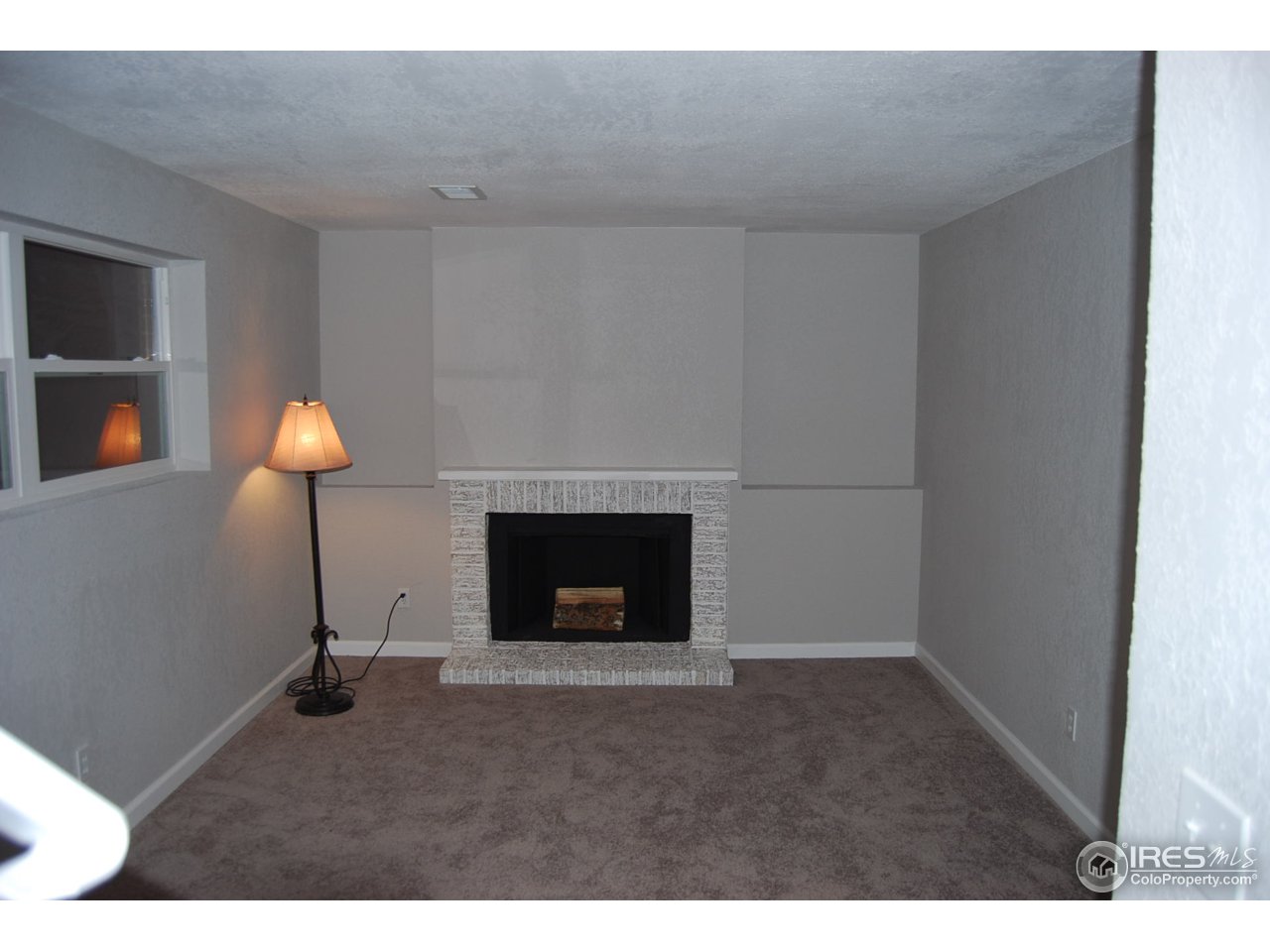 10747 Routt Street Westminster, CO 80021 - Photo 6 of 10 a living room with furniture and a fireplace