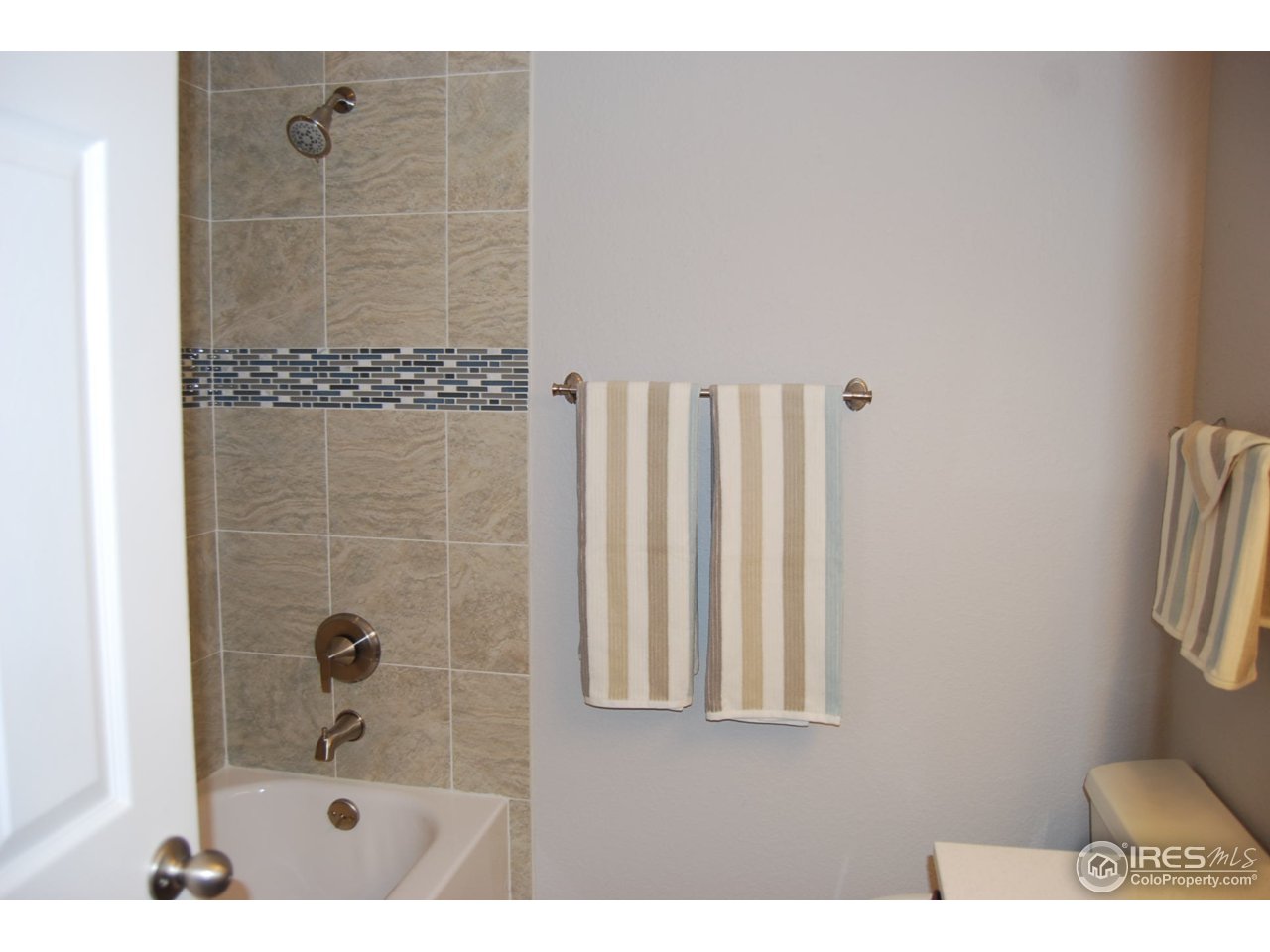 10747 Routt Street Westminster, CO 80021 - Photo 8 of 10 a bathroom with a shower