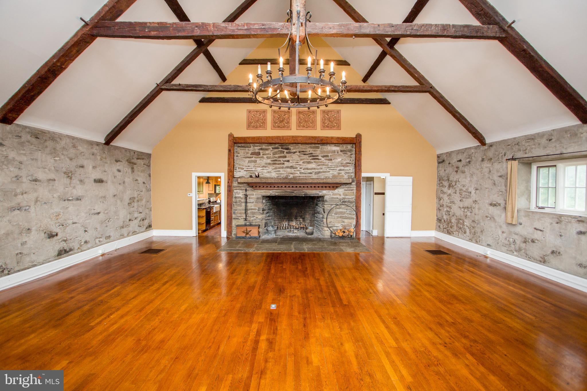 96 Stony Brook Road Hopewell, NJ 08525 - Photo 16 of 49 a view of an empty room with a fireplace and wooden floor