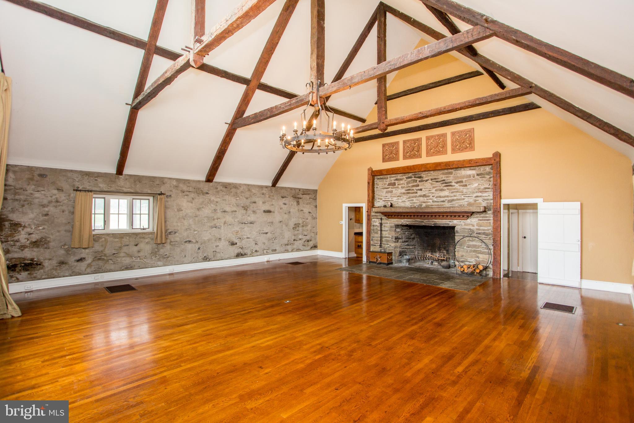 96 Stony Brook Road Hopewell, NJ 08525 - Photo 18 of 49 a living room with a fireplace and a floor to ceiling window