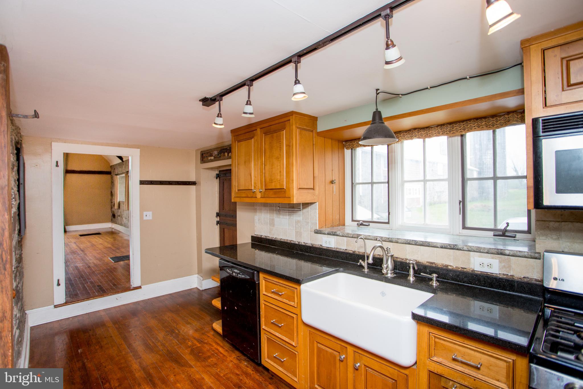 96 Stony Brook Road Hopewell, NJ 08525 - Photo 19 of 49 a kitchen with granite countertop a sink appliances cabinets and a large window