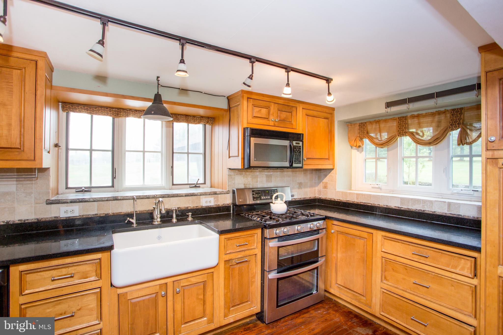 96 Stony Brook Road Hopewell, NJ 08525 - Photo 20 of 49 a kitchen with stainless steel appliances granite countertop a stove a sink and a microwave