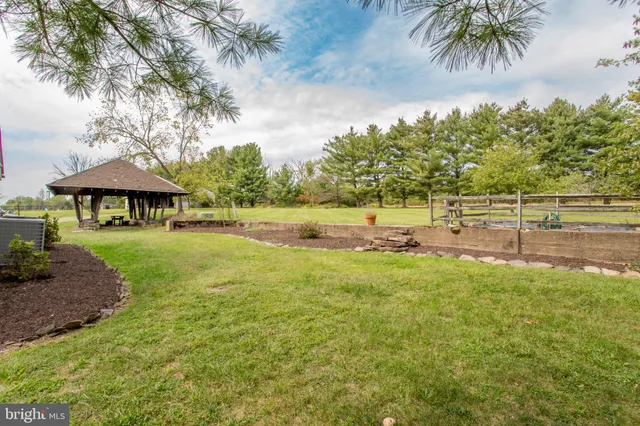 a view of a patio with table and chairs next to a yard