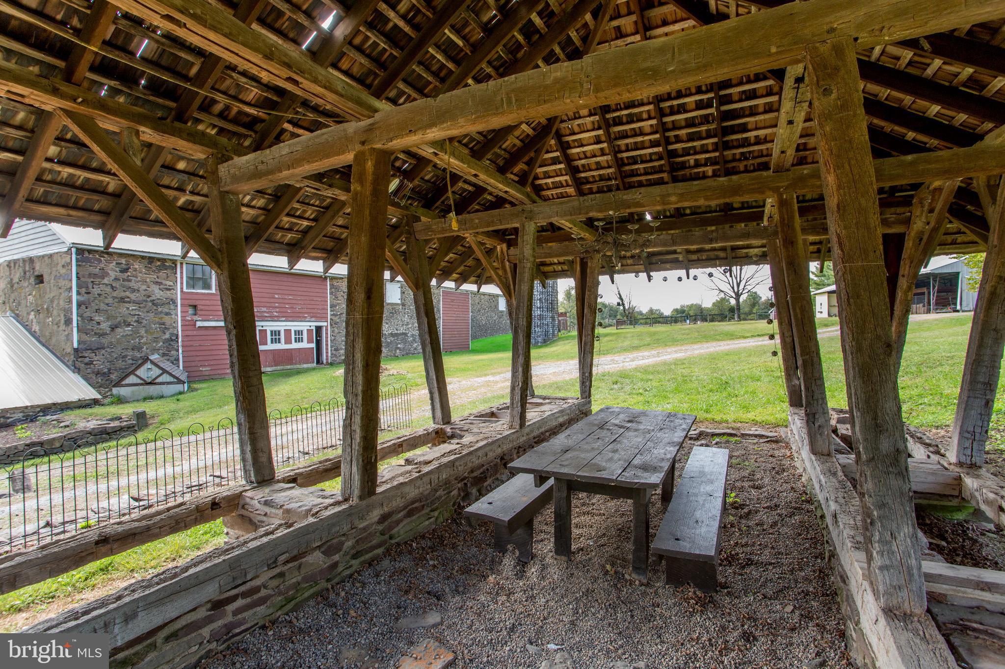96 Stony Brook Road Hopewell, NJ 08525 - Photo 39 of 49 a view of a patio with table and chairs next to a yard