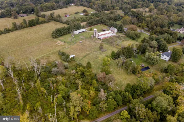 a aerial view of a house with a yard and lake view