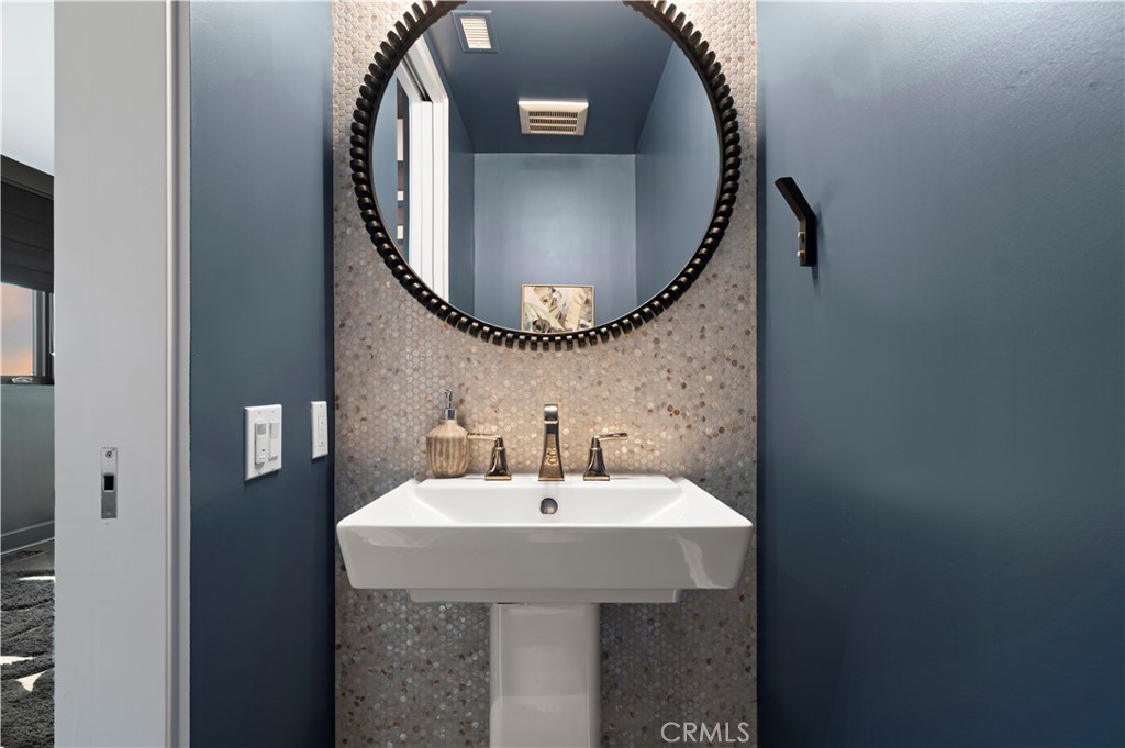 3731 5th Avenue Corona del Mar, CA 92625 - Photo 16 of 36 a bathroom with a sink and a mirror