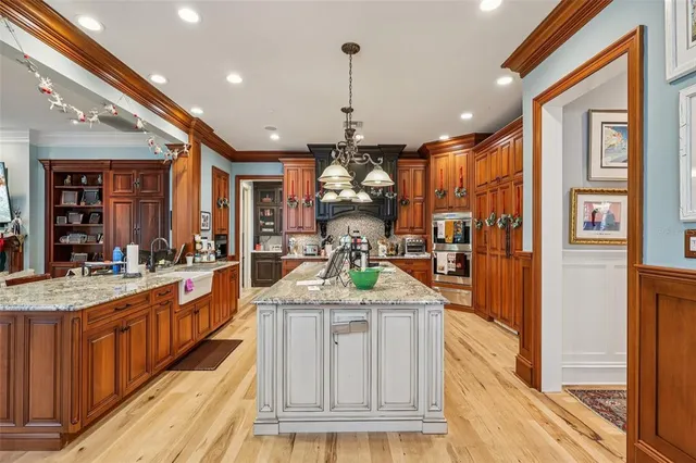 a kitchen with granite countertop a sink a stove and cabinets
