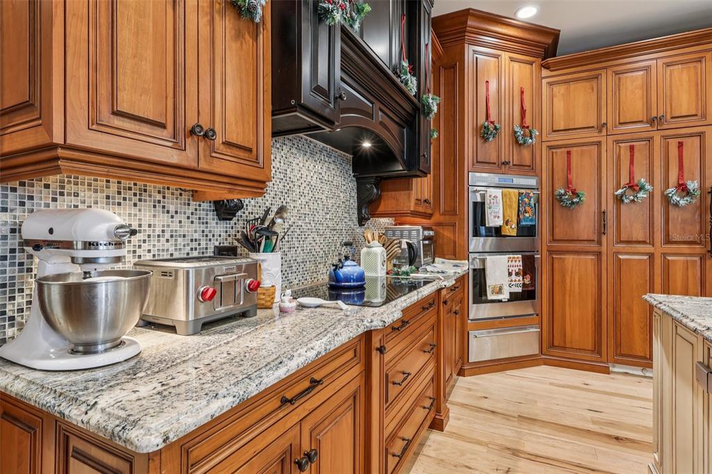 310 Acadia Lane Celebration, FL 34747 - Photo 18 of 52 a kitchen with granite countertop a sink a stove and cabinets