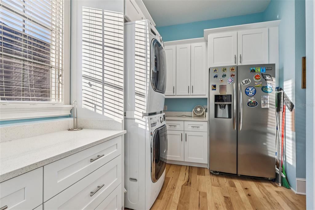 310 Acadia Lane Celebration, FL 34747 - Photo 24 of 52 a kitchen with stainless steel appliances a refrigerator sink and cabinets