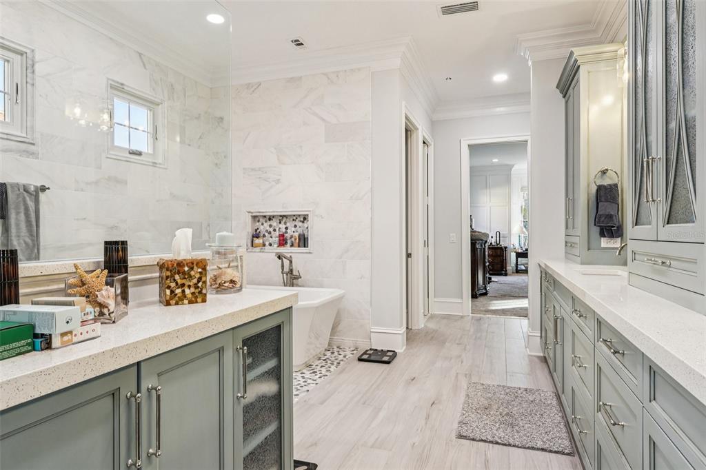310 Acadia Lane Celebration, FL 34747 - Photo 30 of 52 a spacious bathroom with a sink double vanity granite tub shower and a mirror