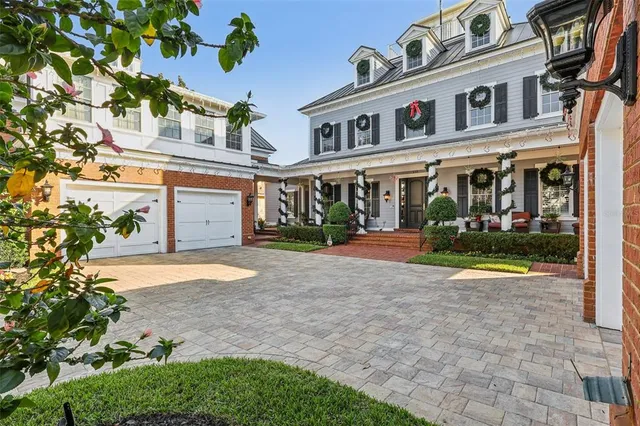 a front view of a building with a garden and plants
