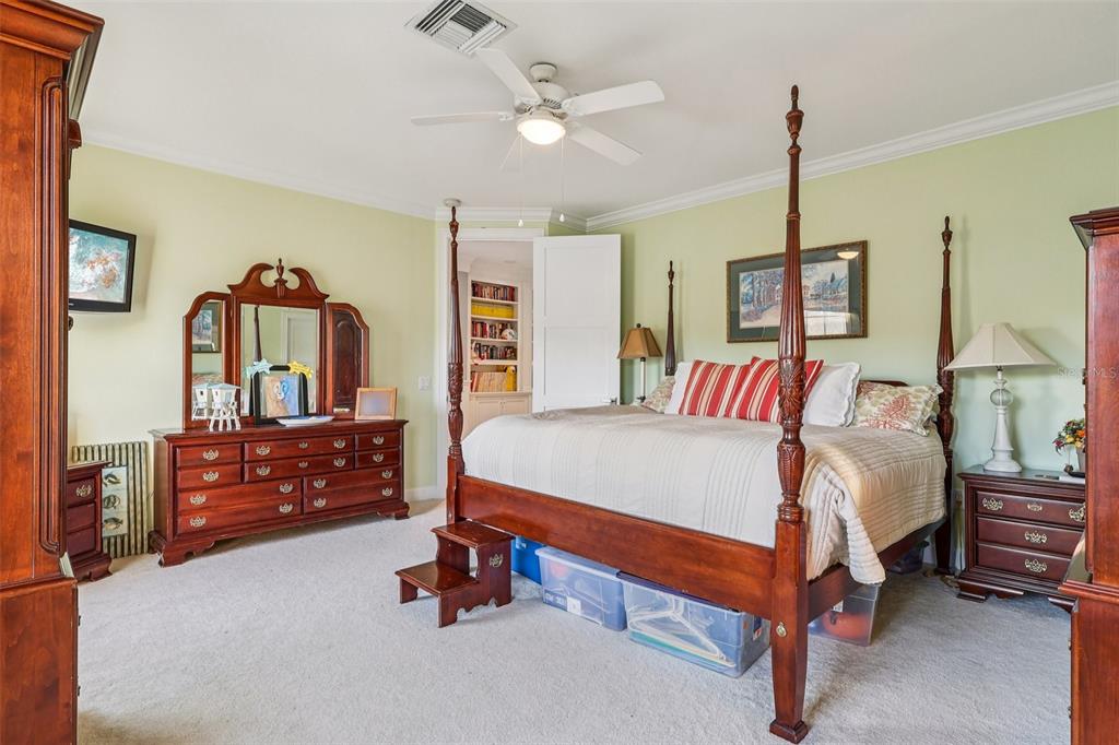 310 Acadia Lane Celebration, FL 34747 - Photo 31 of 52 a bed room with a bed and a chandelier