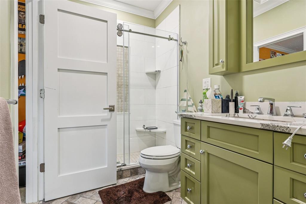 310 Acadia Lane Celebration, FL 34747 - Photo 33 of 52 a bathroom with a granite countertop sink toilet and shower