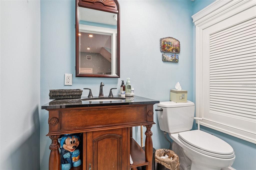 310 Acadia Lane Celebration, FL 34747 - Photo 34 of 52 a bathroom with a toilet a sink and mirror