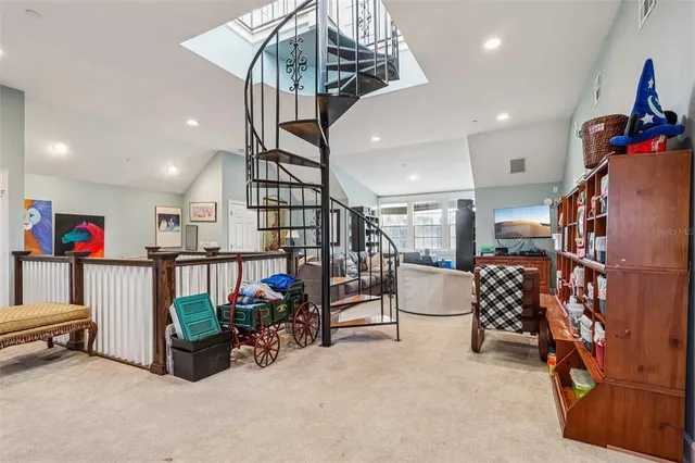 a living room with furniture a projector and a flat screen tv