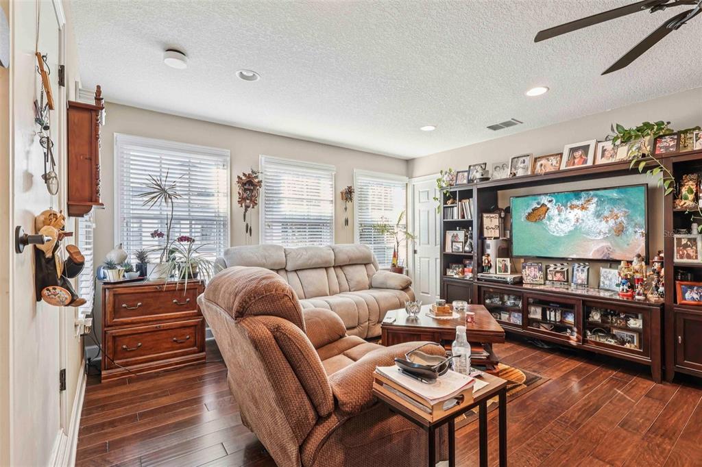 310 Acadia Lane Celebration, FL 34747 - Photo 38 of 52 a living room with furniture a projector and a flat screen tv