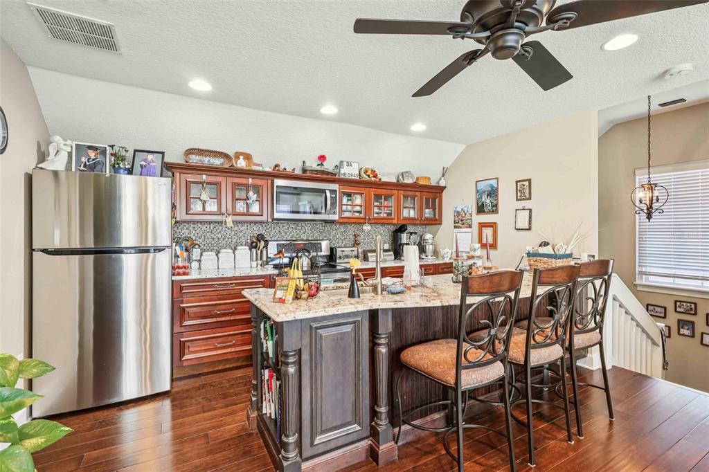310 Acadia Lane Celebration, FL 34747 - Photo 40 of 52 a room with stainless steel appliances a table chairs and a refrigerator