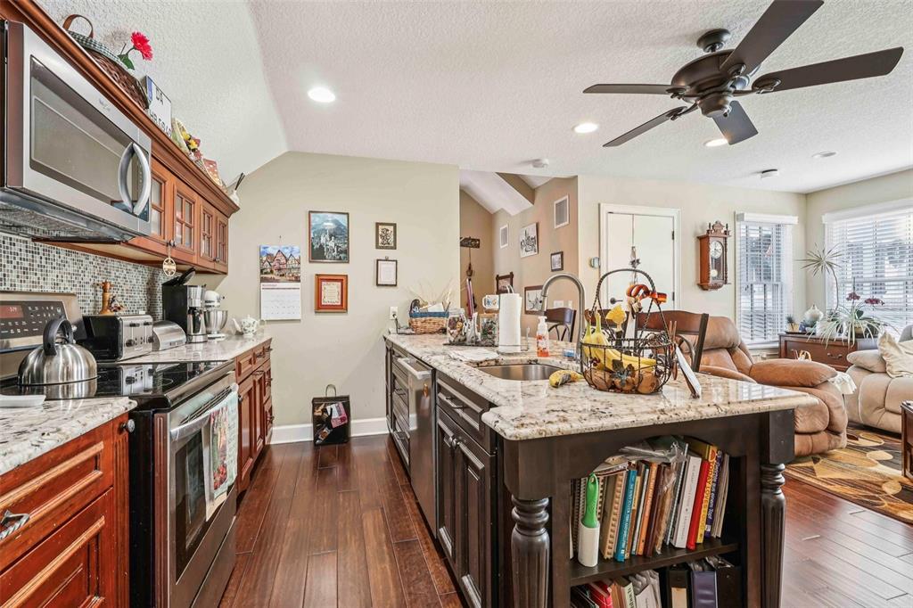 310 Acadia Lane Celebration, FL 34747 - Photo 41 of 52 a open kitchen with stainless steel appliances granite countertop a kitchen island a stove and a sink