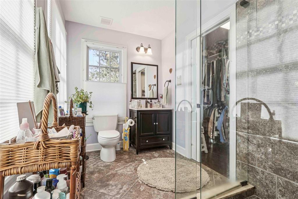310 Acadia Lane Celebration, FL 34747 - Photo 42 of 52 a bathroom with a glass shower door