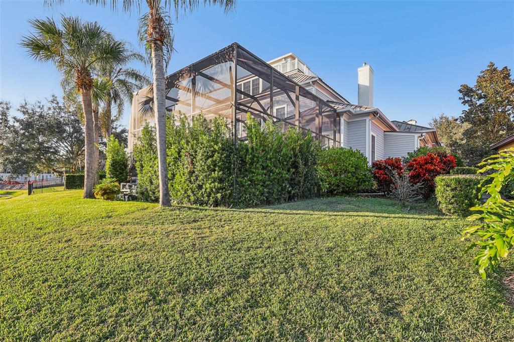 310 Acadia Lane Celebration, FL 34747 - Photo 52 of 52 a view of a white house with a big yard and potted plants