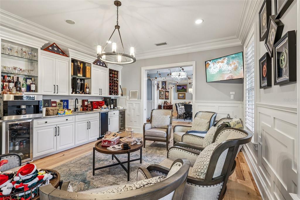 310 Acadia Lane Celebration, FL 34747 - Photo 9 of 52 a living room with furniture a chandelier and kitchen view