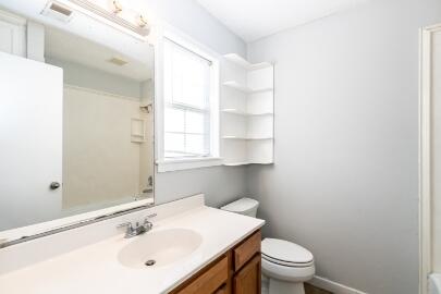 4007 39th Street Lubbock, TX 79413 - Photo 12 of 16 a bathroom with a sink toilet and window