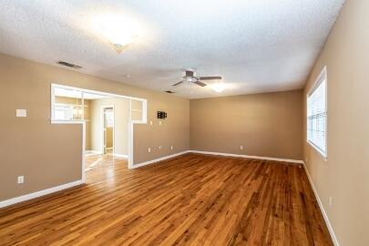4007 39th Street Lubbock, TX 79413 - Photo 3 of 16 wooden floor in an empty room with a window