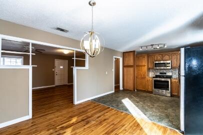 4007 39th Street Lubbock, TX 79413 - Photo 5 of 16 a view of a kitchen with refrigerator and window