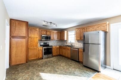 4007 39th Street Lubbock, TX 79413 - Photo 7 of 16 a kitchen with stainless steel appliances granite countertop a refrigerator sink and stove