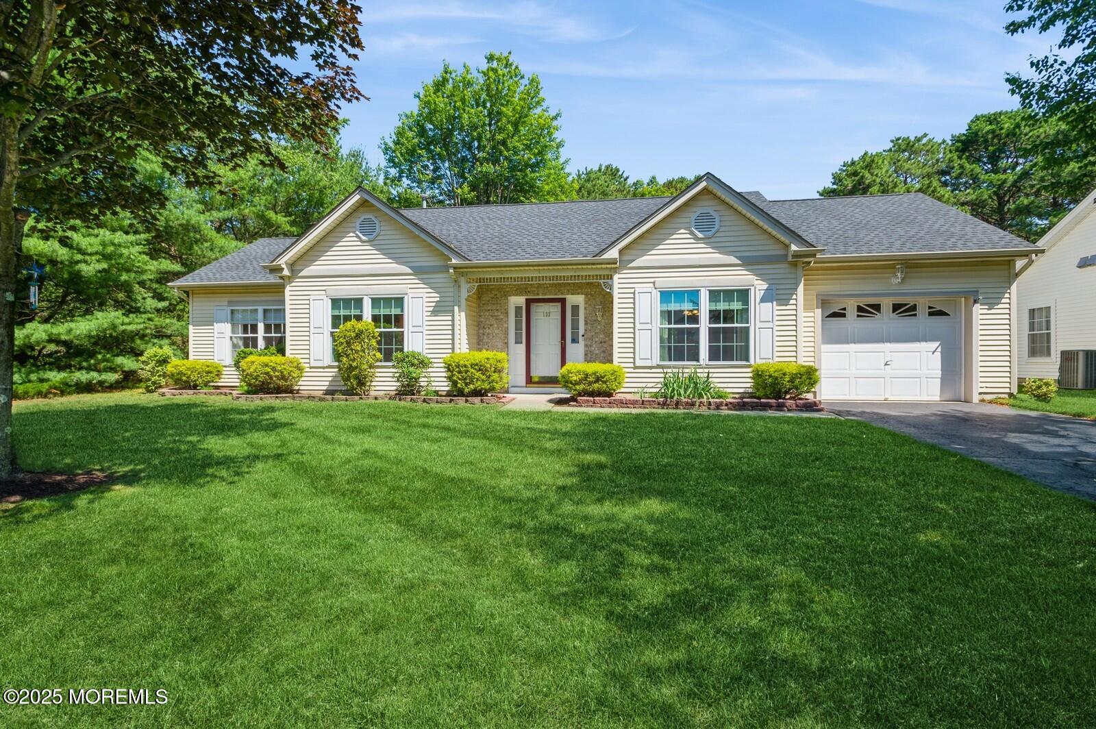 a front view of house with yard and green space