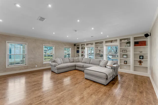 a living room with furniture and a large window