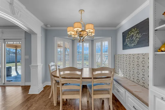 a view of a dining room with furniture wooden floor and chandelier