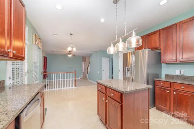 a kitchen with granite countertop a sink cabinets and window