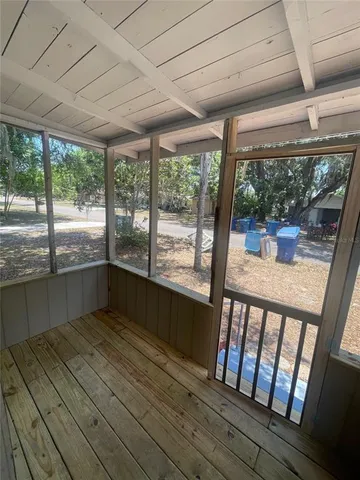 a view of a porch with wooden floor and outdoor space