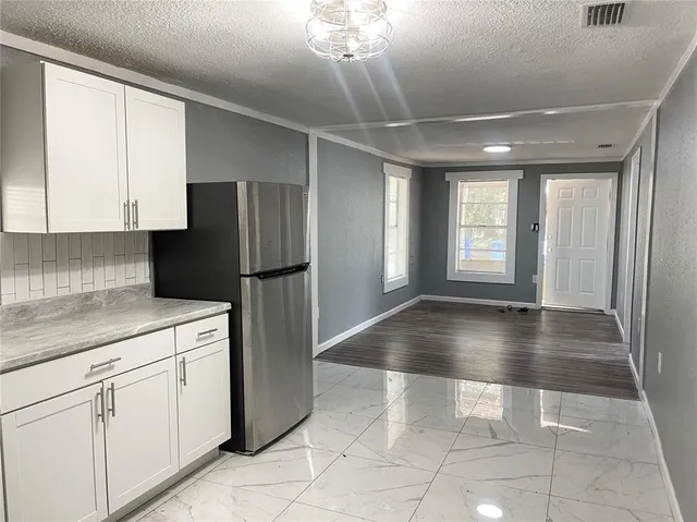 a view of a kitchen with a dishwasher cabinets and a kitchen