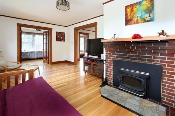 43 Oak Street Newton, MA 02464 - Photo 4 of 20 a living room with furniture a flat screen tv and a fireplace