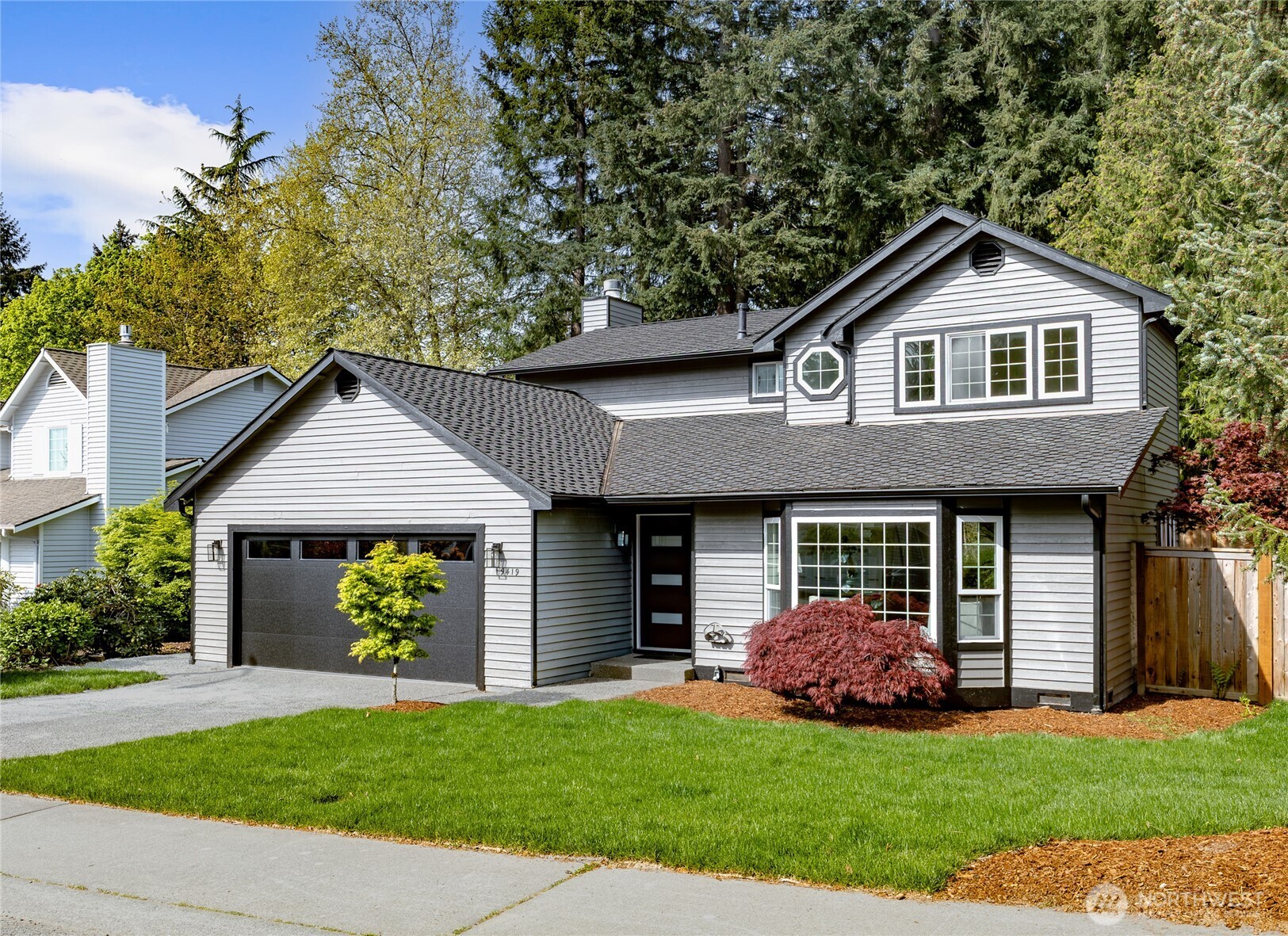 19419 133rd Avenue Southeast Renton, WA 98058 - Photo 2 of 40 a front view of a house with a yard and garage