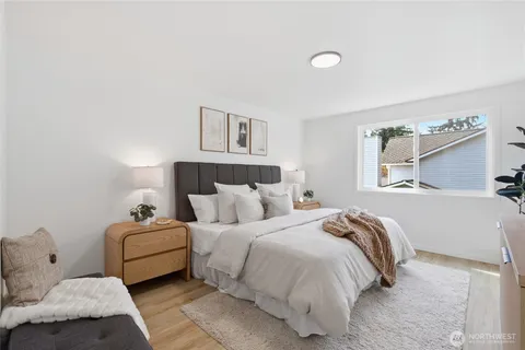 a bedroom with a bed and a wooden floor