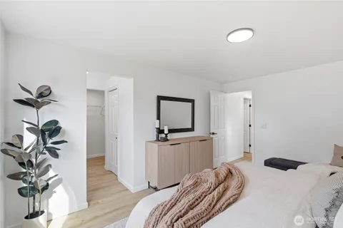 a bedroom with a bed and a couch