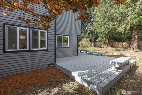 a backyard of a house with table and chairs